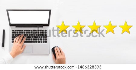 An Elevated View Of Five Star Rating With Receptionist Using A Laptop