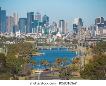 Elevated View Of Melbourne City Over Maribyrnong River. High Rise Modern Skyscrapers And Curving River.