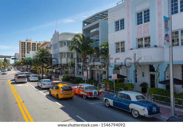 Elevated view on Washington Avenue of vintage\
cars, South Beach, Miami, Florida, United States of America, North\
America 1-10-19