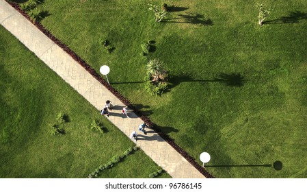 An Elevated View Of People Walking In The Garden