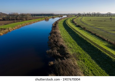 Elevated View Of River And Flood Barrier Or Levee