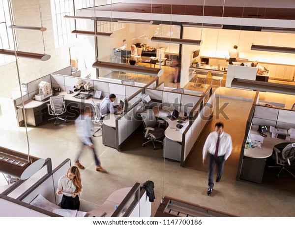 Elevated\
view of staff working in a busy open plan\
office