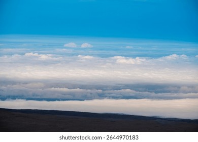 An elevated view from the summit of Mauna Kea on the Big Island of Hawaii, photographed above the clouds in one of the island’s most remote and scenic locations.