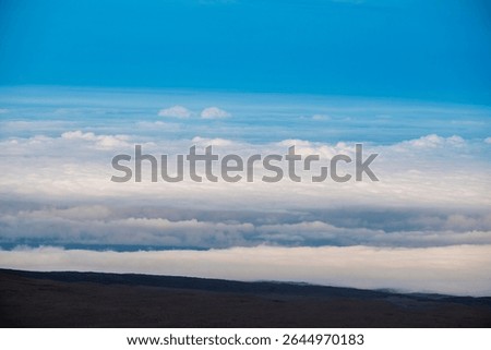 An elevated view from the summit of Mauna Kea on the Big Island of Hawaii, photographed above the clouds in one of the island’s most remote and scenic locations.