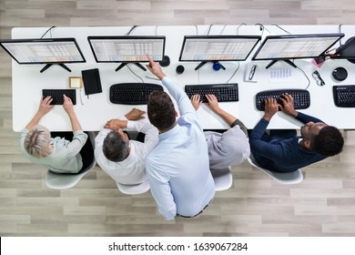 Elevated View Of Team Leader Giving Training To Her Call Center Operator In Office