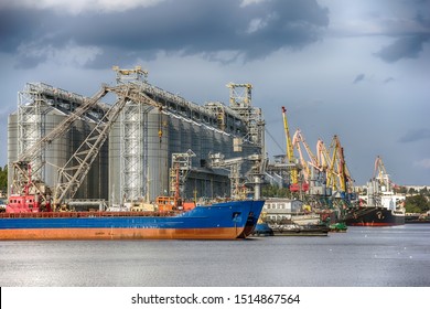 Elevating complex for transshipment of grain and oilseeds as part of a reloading terminal. Transportation of agricultural products and port cranes - Image