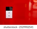 Elevator button on red wall. Elevator Button up and down direction with copy space.