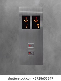 An elevator button panel with up and down arrows on a cement wall.