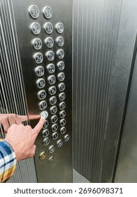 elevator button press, close examination of pressing elevator button in morning routine, zoomedin view capturing finger pressing elevator button during busy morning commute at office