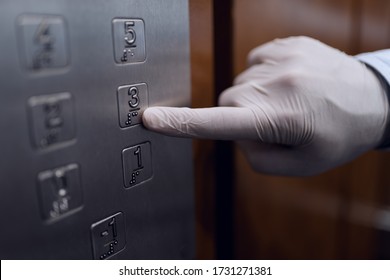 Elevator Buttons With Braille Alphabet For Blind People. Man's Finger (wearing Latex Gloves) Ringing The Button Number 3.