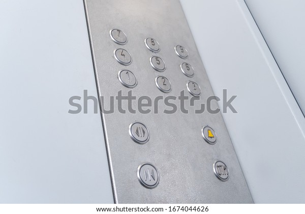 Elevator buttons with Braille, the system\
highlights the button for the 9th\
floor