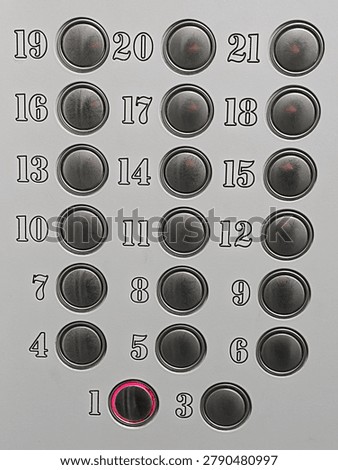 Elevator buttons showing floor 1 pressed on an executive control panel, representing choices and upward movement