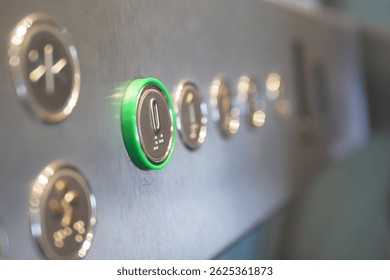 Elevator control panel with illuminated button in modern building