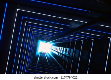 Elevator corridor in the building lit by Blue elumination. Futuristic elevator shaft is located in a high tower. Lift shaft in a residential building. Abstract, background. Bottom view.