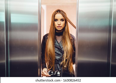 Elevator Door From Inside One Female Young Woman Fashion Model Caucasian With Black Coat Approaching Between The Opening Or Closing Door Metal Metallic