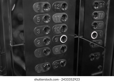 An elevator level button panel, transportation equipment object photo. Photo in dark grey tone.
