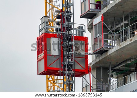 Elevator lifts for workers and material at the construction site.