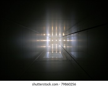Elevator tube with light spots at the end of it