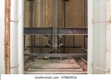 elevator under construction, cable, lift steel welding to install, elevator in instruction site, door open to investigate work adjustment mechanism lift.