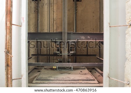 elevator under construction, cable, lift steel welding to install, elevator in instruction site, door open to investigate work adjustment mechanism lift.