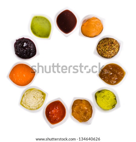 eleven different sauces in a white bowls  on the horizontal surface isolated on white background