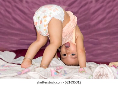 Eleven Months Baby Girl Playing Upside Down In The Room