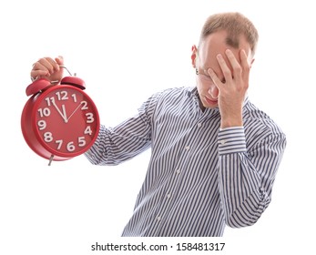 Eleventh hour - stressed man holding clock hiding behind hand isolated on white background