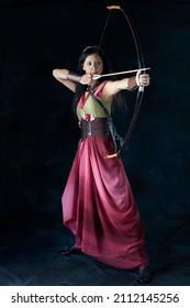 An Elf Warrior Queen Wearing A Laced Bodice And Draped Skirt And Holding A Bow And Arrow