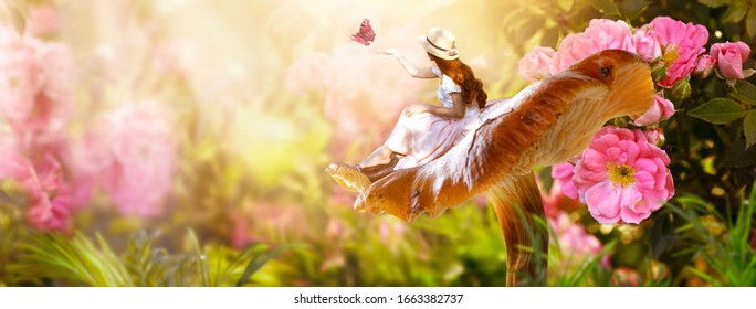 Elf woman in dress and hat sitting on fantasy giant large mushroom releasing butterfly from hand in magical enchanted fairy tale rose flower blooming garden, fairytale floral fabulous background