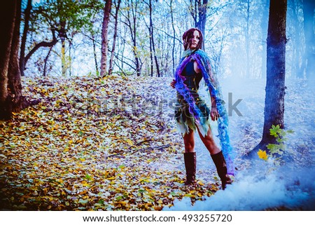 Elf woman in a magical autumn forest