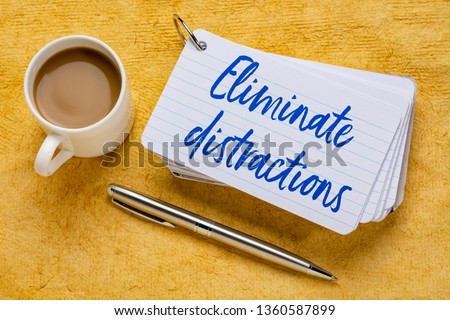Eliminate distractions - handwriting on a stack of index cards with a cup of coffee and  a pen against yellow textured paper