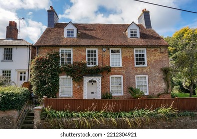 Eling, Hampshire, England - 10.06.2022 - Quaint English Cottage. Front Exterior Of Pretty Brick House Viewed From Road. Rural Home In South Of England 