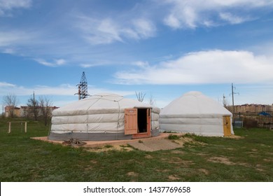 Elista, Russia: 04.19.2019. Museum Of Nomadic Peoples. Two Mongolian Yurts Under A Blue Sky