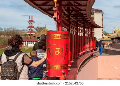 ELISTA, RUSSIA - APRIL 23, 2022: Photo of People turn prayer wheels at the Buddhist temple "Golden Abode of Buddha Shakyamuni".