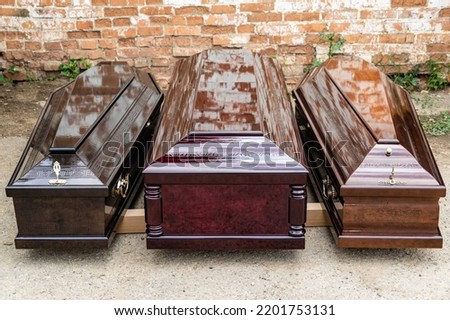 Elite coffins on pallet for transportation. Three types of coffin models made at Elite Grob enterprise.  Kurganinsk. Close-up.Russia 2022