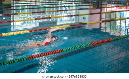 Elite female athlete, professional swimmer during a front crawl swimming workout. Concept of hard training for a competition. - Powered by Shutterstock