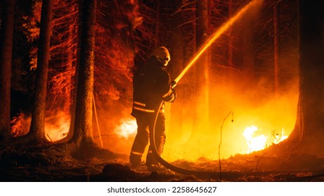 Elite Firefighter Methodically Extinguishing a Large Forest Fire with High-Pressure Water Running From Firehose. Firemen Brigade Rescuing Wildland from Uncontrollable Arson.