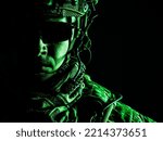 Elite member of US Army ranger in combat helmet and dark glasses. Studio shot, dark black background, looking at camera, dark contrast, toned and colorized