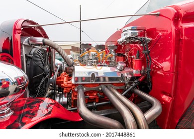 Elizabethtown, KY, USA - July 31, 2021: Classic Red Hotrod With Black Skulls And Flames With Its Engine Exposed On Display During The Cruisin' The Heartland 2021 Car Show In Downtown Elizabethtown, KY