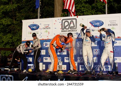 Elkhart Lake Wisconsin, USA - August 18, 2012: Road America Road Race Showcase, ALMS, multi-class sports car and GT motor race. American Le Mans Series Four-hour, timed period. P2 Champions champagne 