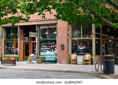 Ellensburg, WA, USA - June 17, 2022; Businesses in the historic Lynch Block of downtown Ellensburg Washington with a bookshop and a full service salon