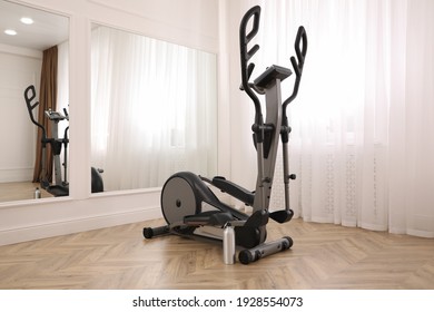 Elliptical machine cross trainer near mirror indoors - Powered by Shutterstock