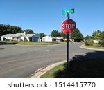 Elm Street and Stop Sign in Residential Community at Road Intersection on a Clear Day with Blue Skies