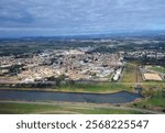 Elmas, Cagliari, Sardinia, Italy, December 18, 2024. The town of 10,000 inhabitants seen from the plane taking off from the airport of the same name. The Cagliari pond runs alongside Elmas.