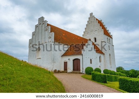 Elmelunde Church in Denmark during a cloudy day.