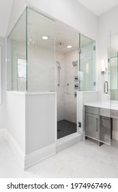 ELMHURST, IL, USA - APRIL 23, 2020: A Large Walk-in Shower In A Luxury Bathroom That's Lined With Glass And Marble Subway Tile Walls And A Dark Tiled Floor.