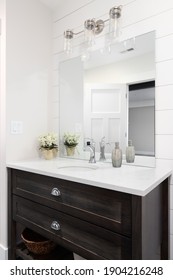 ELMHURST, IL, USA - JANUARY 22, 2021: A Beautiful Bathroom With A Shiplap Wall, Dark Wood Vanity Cabinet, And A Marble Countertop. 