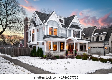 ELMHURST, IL, USA - JANUARY 30, 2020: A large suburban house at sunset with beautiful, dramatic clouds and snow on the ground.