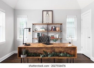 ELMHURST, IL, USA - JUNE 5, 2021:  A Cozy Home Office With A Large Wood Desk, Wrought Iron And Wood Shelving, And Farmhouse Decorations.