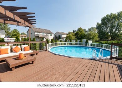 ELMHURST, IL, USA - SEPTEMBER 25, 2020: A Backyard Deck With A Pergola Over Some Seating And A Large Above Ground Pool.